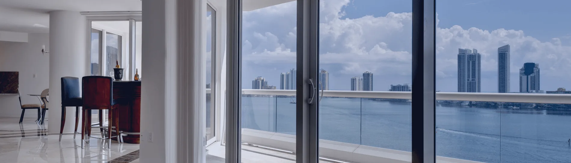 Sliding glass impact doors opening onto a Miami bayfront balcony